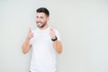 Young handsome man wearing casual white t-shirt over isolated background pointing fingers to camera with happy and funny face Royalty Free Stock Photo