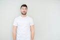 Young handsome man wearing casual white t-shirt over isolated background smiling looking side and staring away thinking Royalty Free Stock Photo