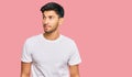 Young handsome man wearing casual white tshirt smiling looking to the side and staring away thinking Royalty Free Stock Photo