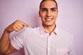 Young handsome man wearing elegant shirt over pink isolated background with surprise face pointing finger to himself Royalty Free Stock Photo