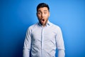 Young handsome man wearing elegant shirt standing over isolated blue background afraid and shocked with surprise expression, fear Royalty Free Stock Photo