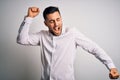 Young handsome man wearing elegant shirt standing over isolated white background Dancing happy and cheerful, smiling moving casual Royalty Free Stock Photo