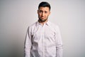 Young handsome man wearing elegant shirt standing over isolated white background depressed and worry for distress, crying angry Royalty Free Stock Photo