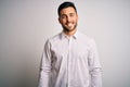 Young handsome man wearing elegant shirt standing over isolated white background with a happy and cool smile on face Royalty Free Stock Photo