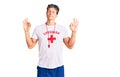 Young handsome man wearing lifeguard t shirt and whistle relax and smiling with eyes closed doing meditation gesture with fingers