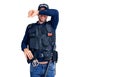 Young handsome man wearing police uniform covering eyes with arm smiling cheerful and funny Royalty Free Stock Photo