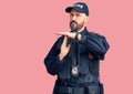 Young handsome man wearing police uniform doing time out gesture with hands, frustrated and serious face Royalty Free Stock Photo