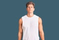 Young handsome man wearing sleveeless t shirt with serious expression on face Royalty Free Stock Photo