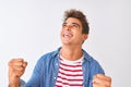 Young handsome man wearing striped t-shirt and denim shirt over isolated white background very happy and excited doing winner Royalty Free Stock Photo