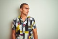 Young handsome man wearing summer shirt over white isolated background looking away to side with smile on face, natural expression Royalty Free Stock Photo