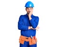 Young handsome man wearing worker uniform and hardhat relaxed with serious expression on face Royalty Free Stock Photo