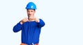 Young handsome man wearing worker uniform and hardhat suffering of backache, touching back with hand, muscular pain