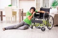 Young handsome man in wheelchair at home Royalty Free Stock Photo