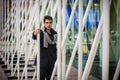 Young Handsome Man among White Metal Bars Royalty Free Stock Photo