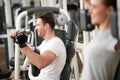 Young handsome man working out in fitness center. Royalty Free Stock Photo