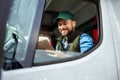 Handsome man working in towing service and driving his truck