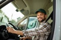 Handsome man working in towing service and driving his truck