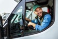 Handsome man working in towing service and driving his truck