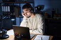 Young handsome man working using computer laptop at night thinking looking tired and bored with depression problems with crossed Royalty Free Stock Photo