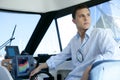 Young handsome man on a yacht boat interior