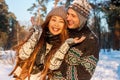 A young handsome man of European appearance and a young Asian girl in a park on the nature in winter Royalty Free Stock Photo