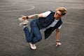 Young handsome man in stylish denim dress dancing hip hop. Royalty Free Stock Photo