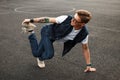 Young handsome man in stylish denim dress dancing on the street. Royalty Free Stock Photo