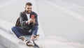 Young handsome men using smartphone in a city. Smiling student man texting on his mobile phone. Royalty Free Stock Photo