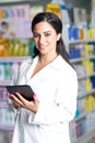 Young handsome pharmacist with a tablet in a drug store