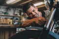 young handsome professional automechanic fixing motorbike Royalty Free Stock Photo