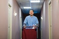 Young handsome pushing cleaning cart - a series of HOTEL images.