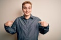 Young handsome redhead man wearing casual shirt standing over isolated white background looking confident with smile on face, Royalty Free Stock Photo