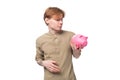 young handsome redhead student man holding piggy bank with savings Royalty Free Stock Photo