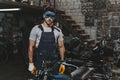 young handsome repairman in goggles with circular saw in workshop Royalty Free Stock Photo