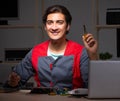 Young handsome repairman repairing computer