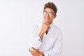 Young handsome sciencist man wearing glasses and coat over  white background looking confident at the camera smiling with Royalty Free Stock Photo