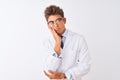 Young handsome sciencist man wearing glasses and coat over  white background thinking looking tired and bored with Royalty Free Stock Photo