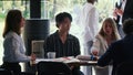 Young handsome serious 20s Chinese manager businessman is stressed at busy modern office workplace team table meeting. Royalty Free Stock Photo