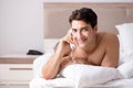 Young handsome shirtless guy showing nude torso on bed at h Royalty Free Stock Photo