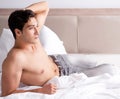 Young handsome shirtless guy showing nude torso sexy on bed at h Royalty Free Stock Photo