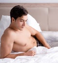 Young handsome shirtless guy showing nude torso sexy on bed at h Royalty Free Stock Photo