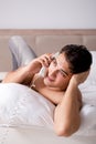 Young handsome shirtless guy showing nude torso on bed at h Royalty Free Stock Photo