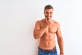 Young handsome shirtless man showing muscular body over isolated background looking confident at the camera smiling with crossed Royalty Free Stock Photo