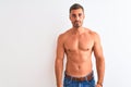 Young handsome shirtless man showing muscular body over isolated background Relaxed with serious expression on face Royalty Free Stock Photo