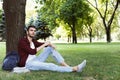 Young handsome man sitting on grass outdoors Royalty Free Stock Photo