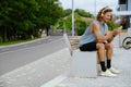 Young handsome smiling sporty long-haired man in headphones with phone Royalty Free Stock Photo