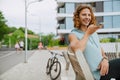 Young handsome smiling sporty long-haired man talking phone on speakerphone Royalty Free Stock Photo