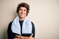 Young handsome sportsman wearing towel standing over isolated white background happy face smiling with crossed arms looking at the Royalty Free Stock Photo