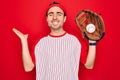 Young handsome sporty man with blue eyes playing baseball using glove and ball very happy and excited, winner expression Royalty Free Stock Photo