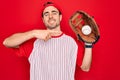 Young handsome sporty man with blue eyes playing baseball using glove and ball very happy pointing with hand and finger Royalty Free Stock Photo